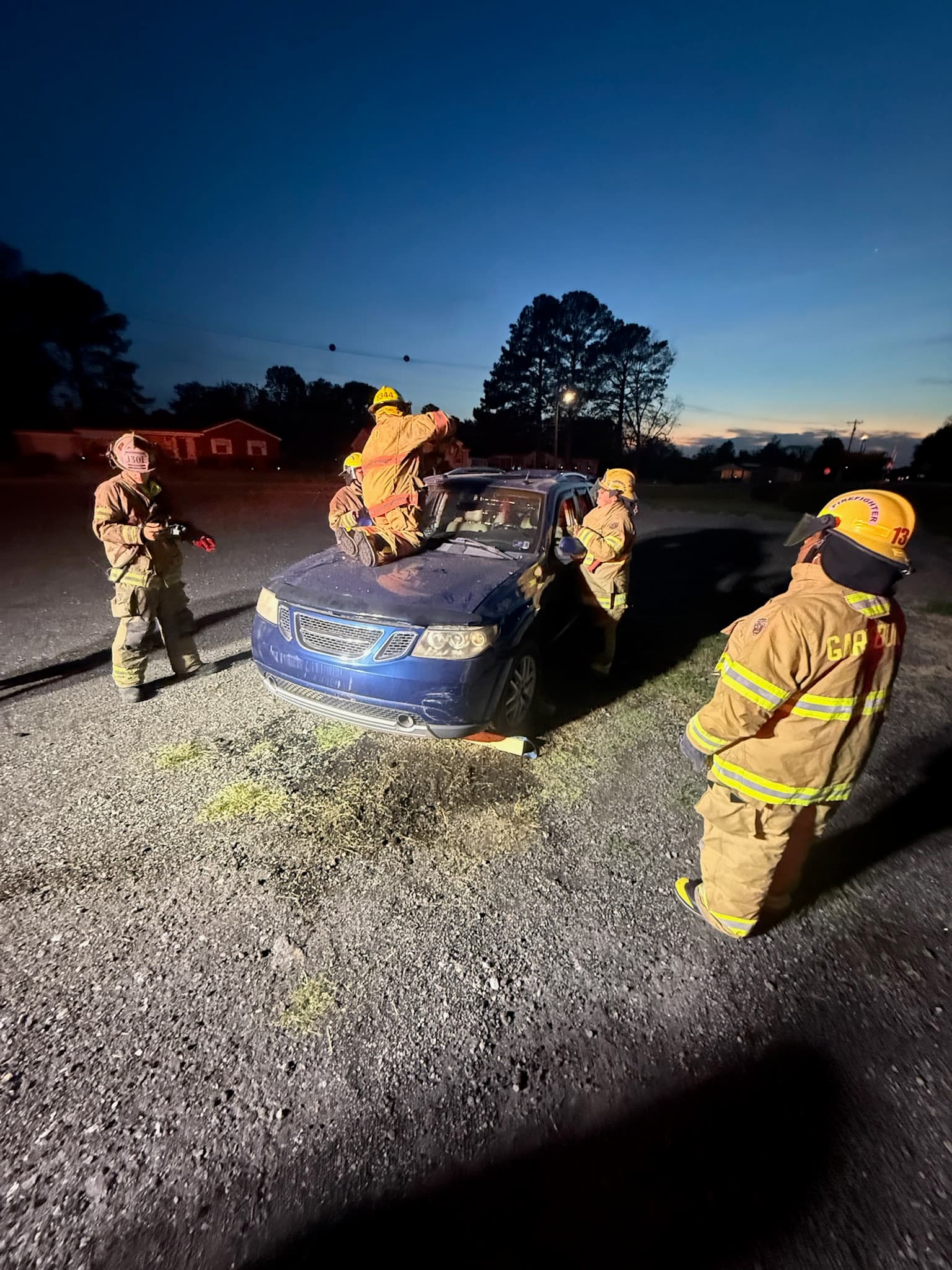 Garysburg firefighters training around a vehicle at dusk